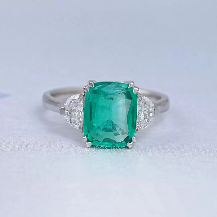 front view of green cushion and half moon cut lab diamond three stone engagement ring