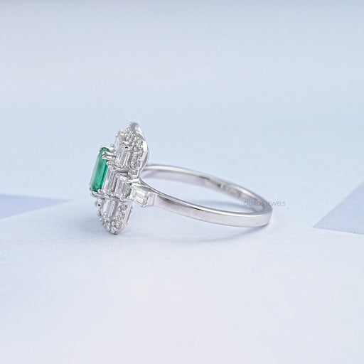 side view of green emerald round diamond halo gemstone engagement ring