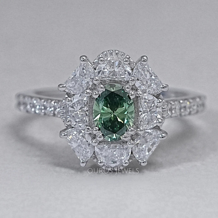 front view of green oval cut diamond half moon halo engagement ring