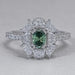 front view of green oval cut diamond half moon halo engagement ring