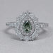 front view of green pear cut surround double halo diamond engagement ring