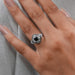 princess cut black diamond half moon halo engagement ring on model's hand