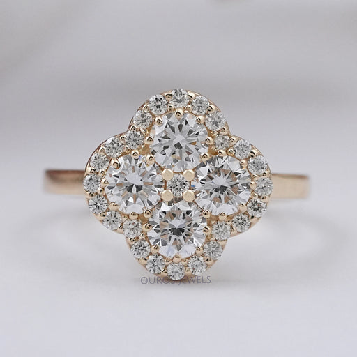 top view of round lab diamond flower halo anniversary ring on grey fabric