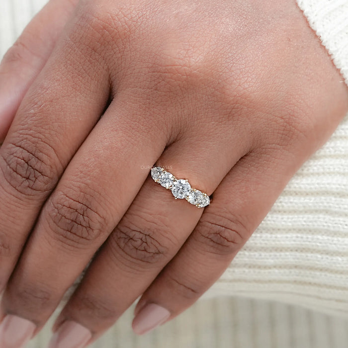 round and heart cut lab diamond five stone engagement ring on model's finger