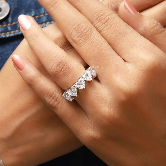 heart cut lab grown diamond five stone wedding ring on model's finger
