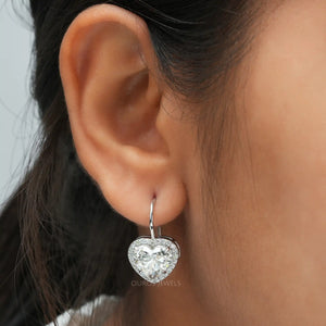 [a close up of a woman's ear with a heart shaped earring]-[Ouros Jewels]