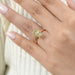 old mine moval cut yellow diamond solitaire engagement ring shown on hand