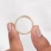 Mens Brushed Gold Ring hold in between two fingers.