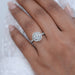 round cut lab diamond halo engagement ring on model's finger
