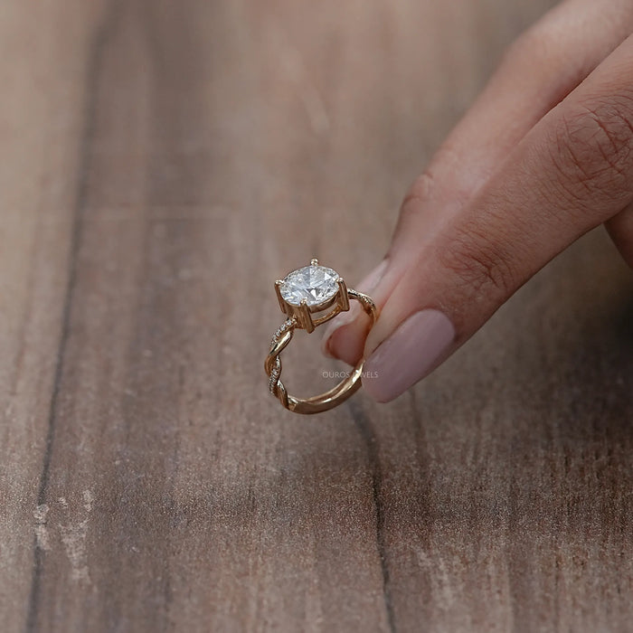 side view of twisted round-cut lab diamond solitaire accent anniversary ring