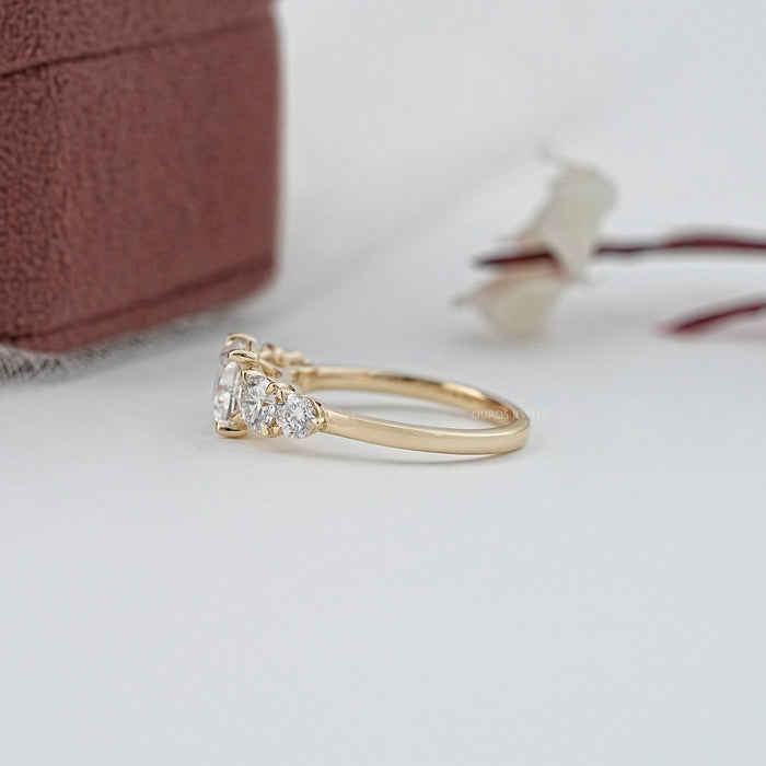 side view of cushion cut diamond five stone engagement ring in yellow gold band
