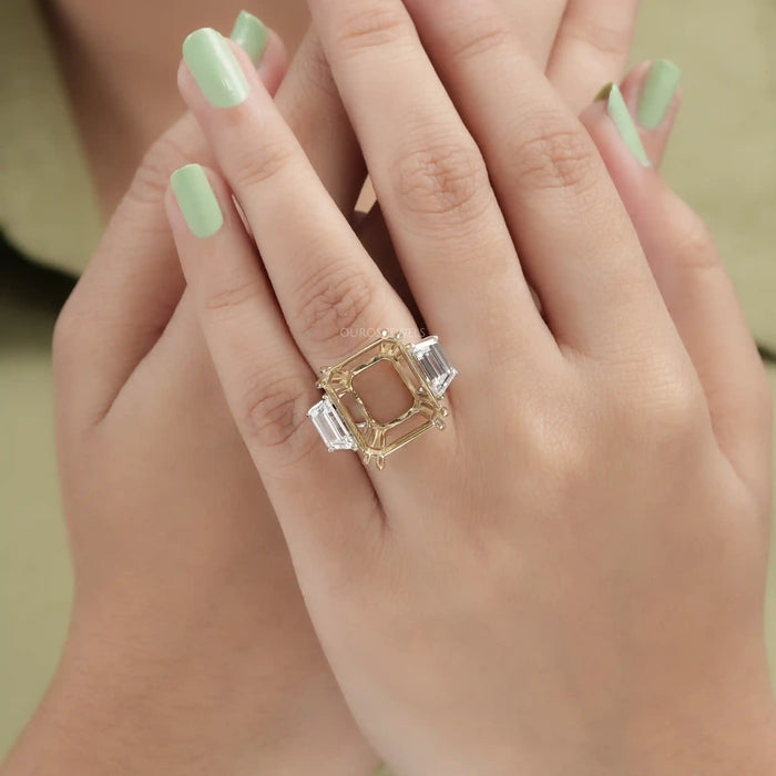 step-cut trapezoid semi-mount three-stone wedding ring in finger