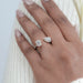 pear and emerald-cut lab diamond halo toi et moi engagement ring on model's finger