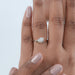 pear cut lab diamond curved solitaire engagement ring on model's hand
