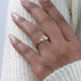 oval-cut and pear-cut lab diamond toi et moi engagement ring on model's finger