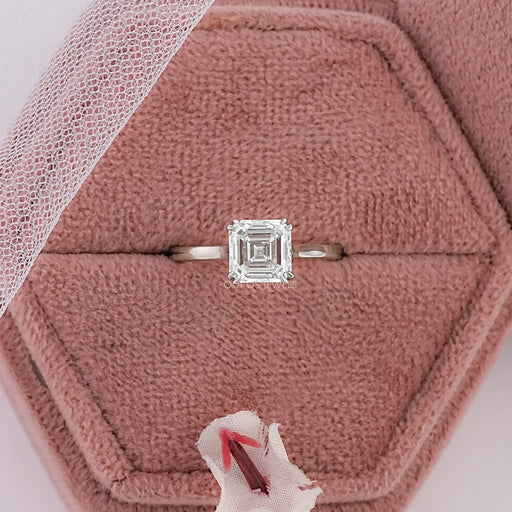 asscher cut diamond double prong engagement ring in jewelry box