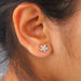 marquise cut manufactured diamond flower stud earrings yellow gold on ear