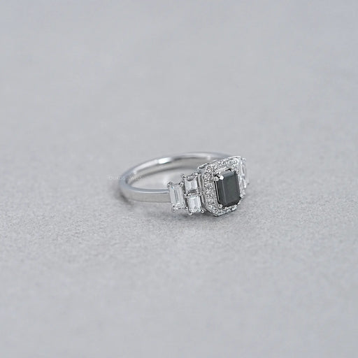 side view of black emerald-cut diamond solitaire accent halo engagement ring