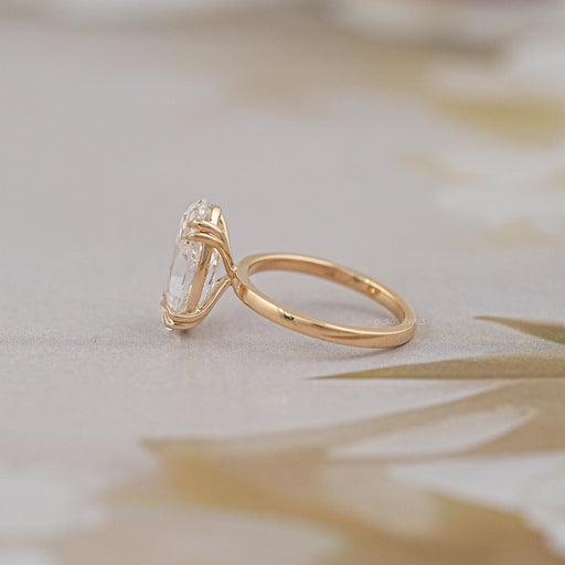 side view of old mine moval double prong engagement ring in yellow gold band