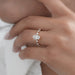 old mine moval cut lab diamond solitaire accent engagement ring on model's finger