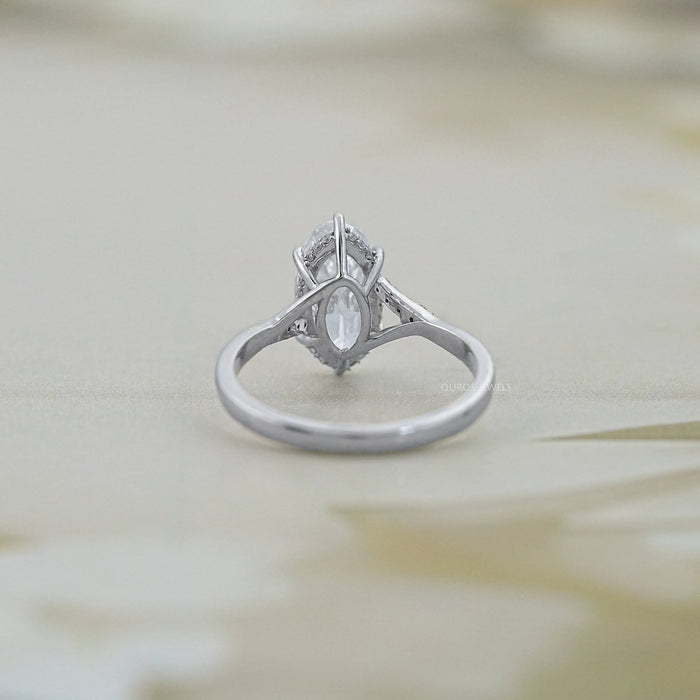 back view of old mine moval cut lab diamond split shank wedding ring on grey fabric