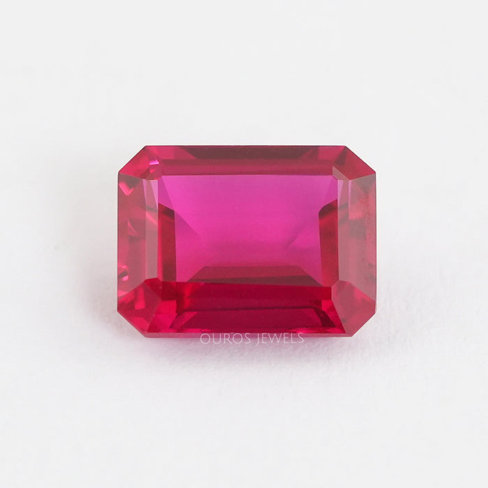 front view of emerald shape light red ruby gemstone