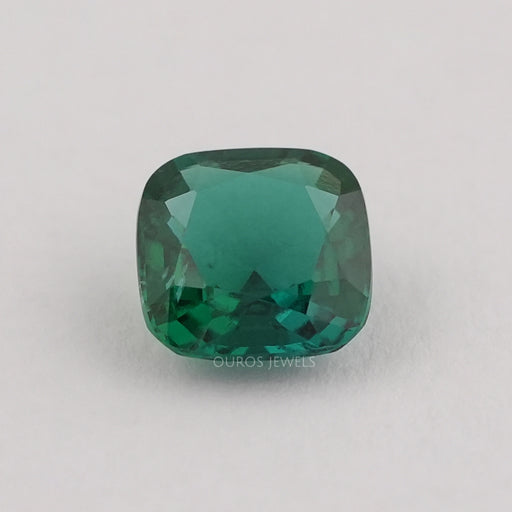 front view of dark green zambian cushion cut lab grown gemstone