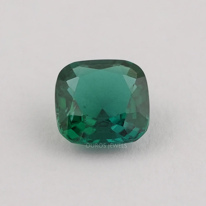 front view of dark green zambian cushion cut lab grown gemstone