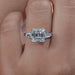 asscher cut lab diamond double prong three stone engagement ring's front view on finger