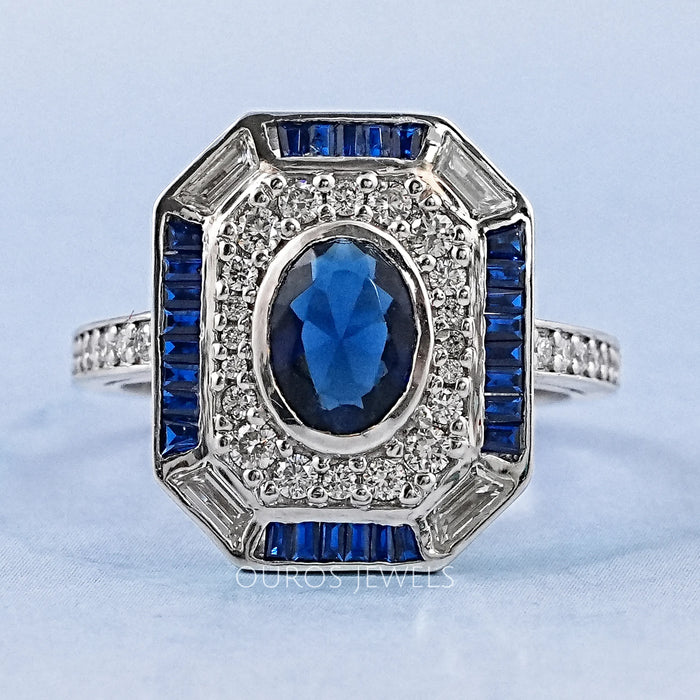 blue oval and baguette cut halo gemstone engagement ring's front view