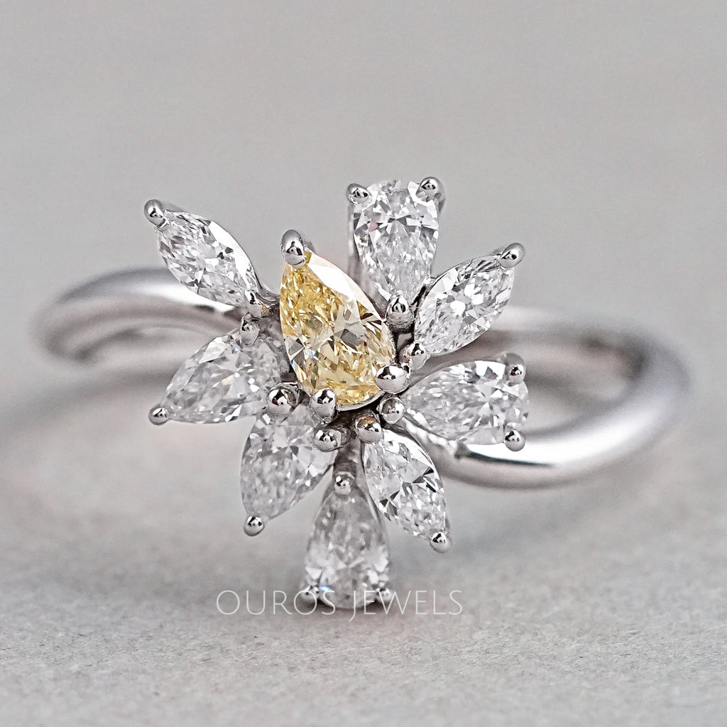 front view of yellow pear and marquise-cut cluster diamond colored engagement ring