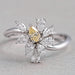 front view of yellow pear and marquise-cut cluster diamond colored engagement ring