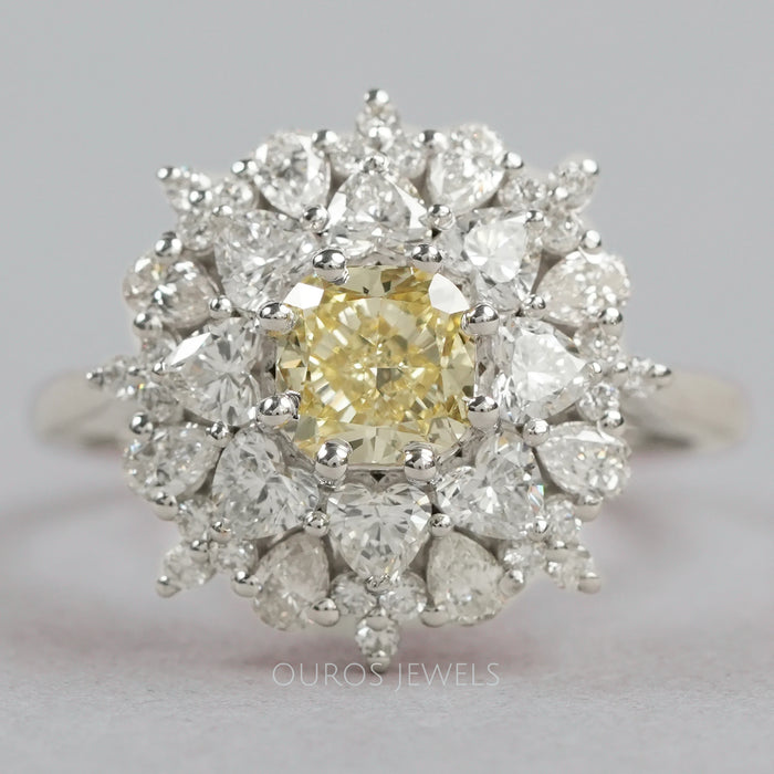 top view of fancy yellow cushion cut diamond with heart & pear sunburst halo ring