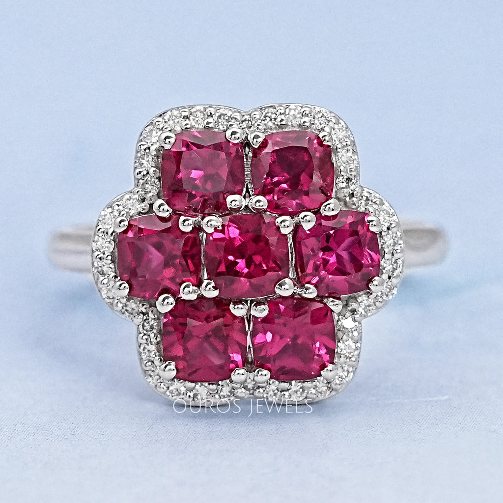 top view of red ruby cushion cut & round diamond floral halo engagement ring