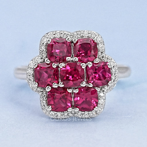 top view of red ruby cushion cut & round diamond floral halo engagement ring