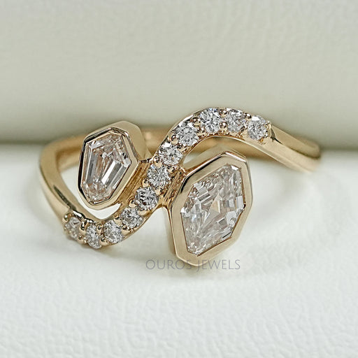 top view of step cut shield diamond bezel set bypass engagement ring