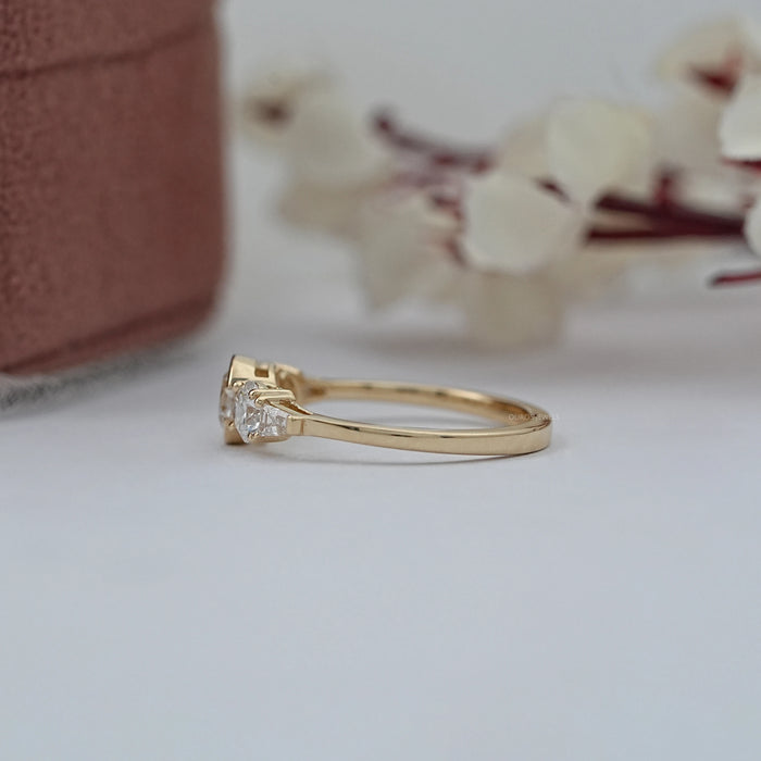 side view of round and tapered baguette diamond half bezel five stone engagement ring