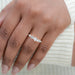 round and pear cut lab diamond five stone engagement ring on model's finger