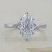 front view of old mine moval cut lab diamond split shank wedding ring on grey fabric