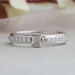 front view of olive emerald-cut diamond solitaire accent ring with white gold band