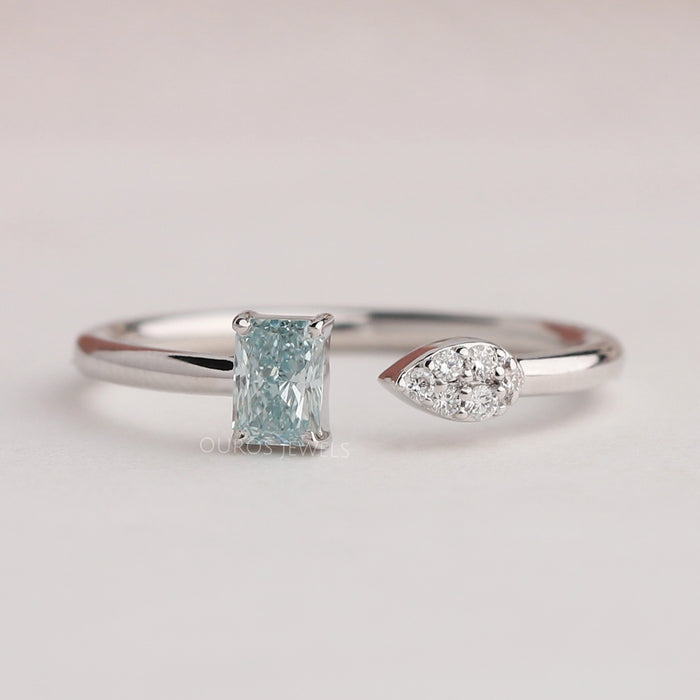 front view of green radiant-cut lab diamond open cuff dainty wedding band on fabric