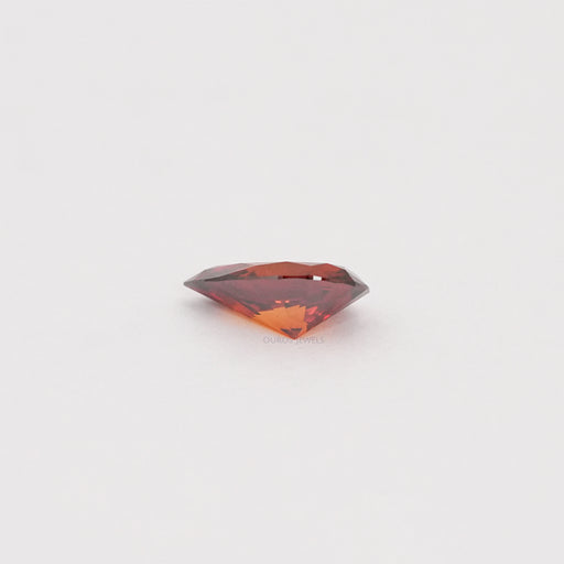 side view of red pear shaped lab created diamond loose