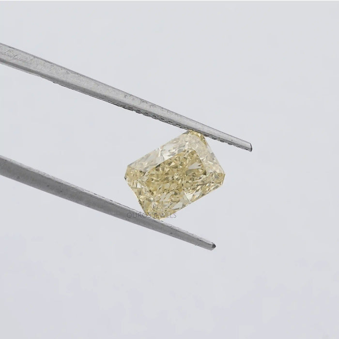 2.15 carat yellow radiant lab grown diamond loose held with tweezer