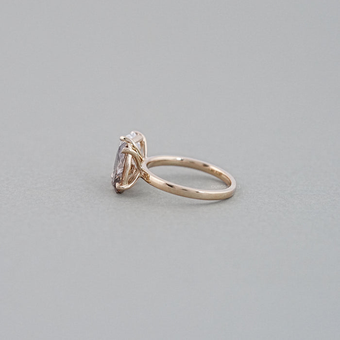 side view of emerald and champagne oval-cut diamond toi et moi engagement ring