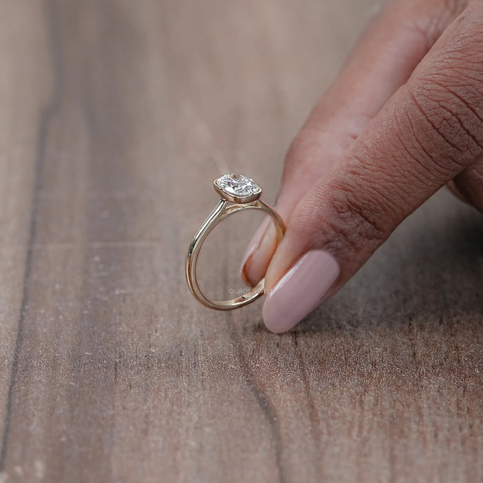 side view of oval cut diamond button back solitaire engagement ring