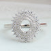 front view of oval-cut semi-mount cluster diamond engagement ring on fabric