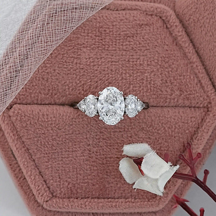 oval and trillion cut lab diamond five stone engagement ring in jewelry box