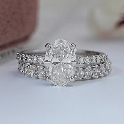 front view of oval-cut lab diamond bridal engagement ring set with white gold band