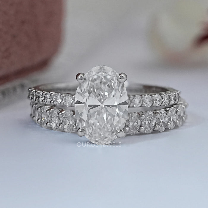 front view of oval-cut lab diamond bridal engagement ring set with white gold band