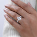 oval cut lab diamond three stone engagement ring in model's finger